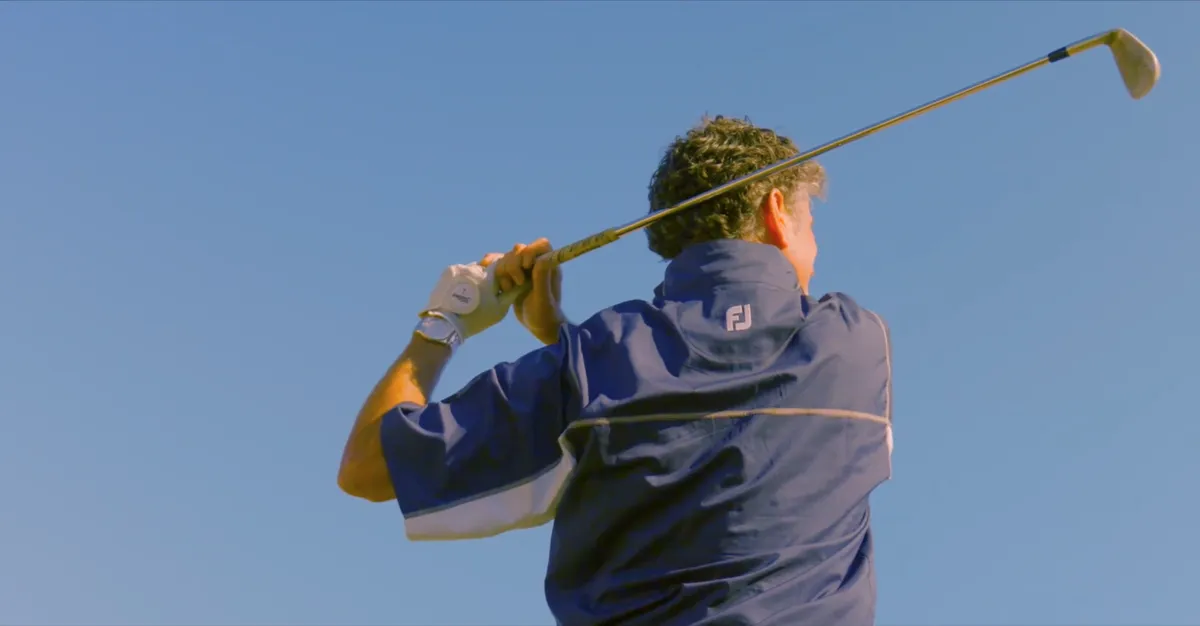 Golfer at the top of the backswing on the range